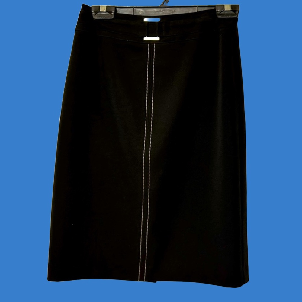 Black skirt with little buckle detail in front and white stitching.